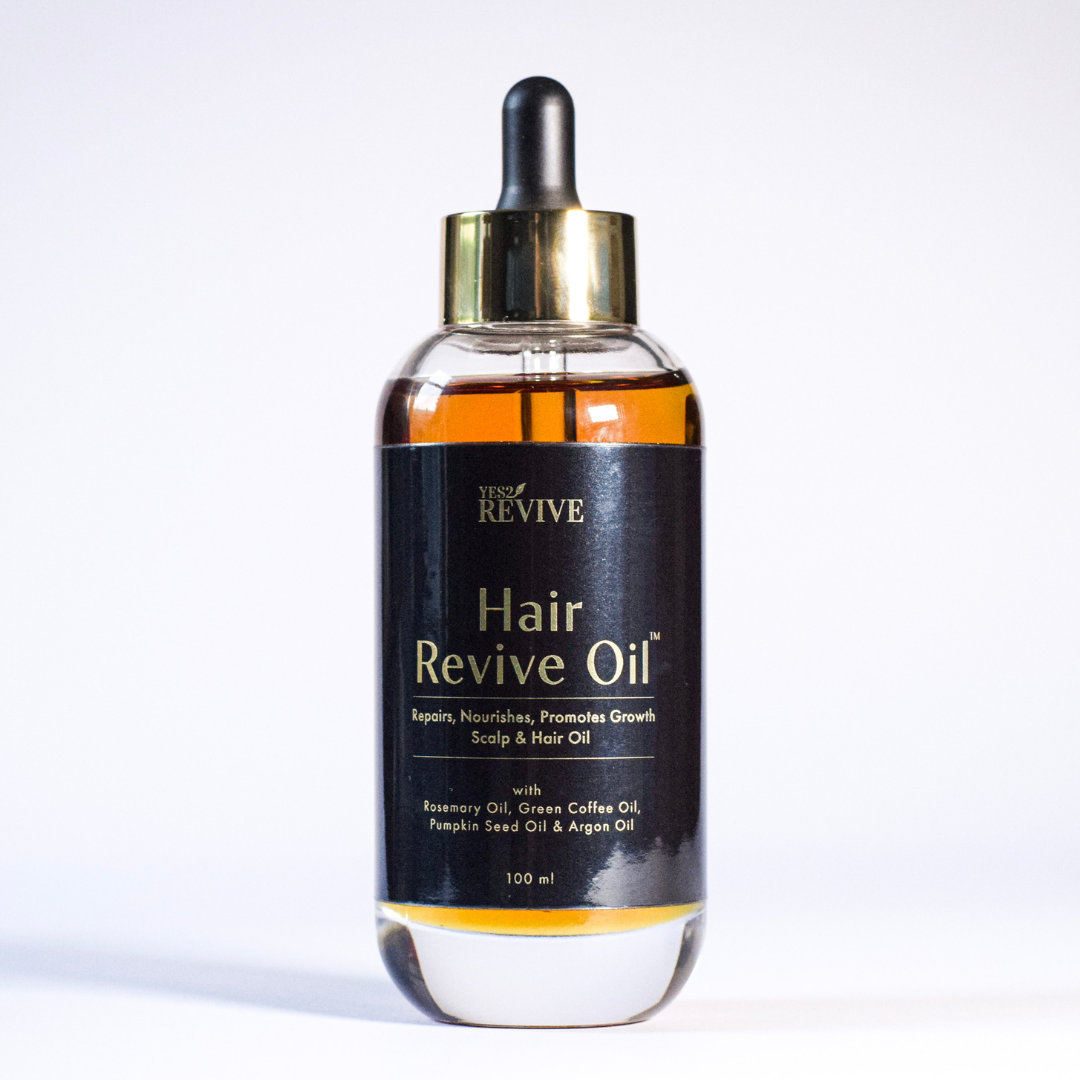 A stylish bottle of Hair Revive Oil showcasing its key ingredients for hair growth and repair